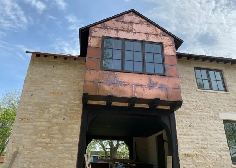 Copper metal panel facade on a stone building for Metal Roof Coating in North Kansas City