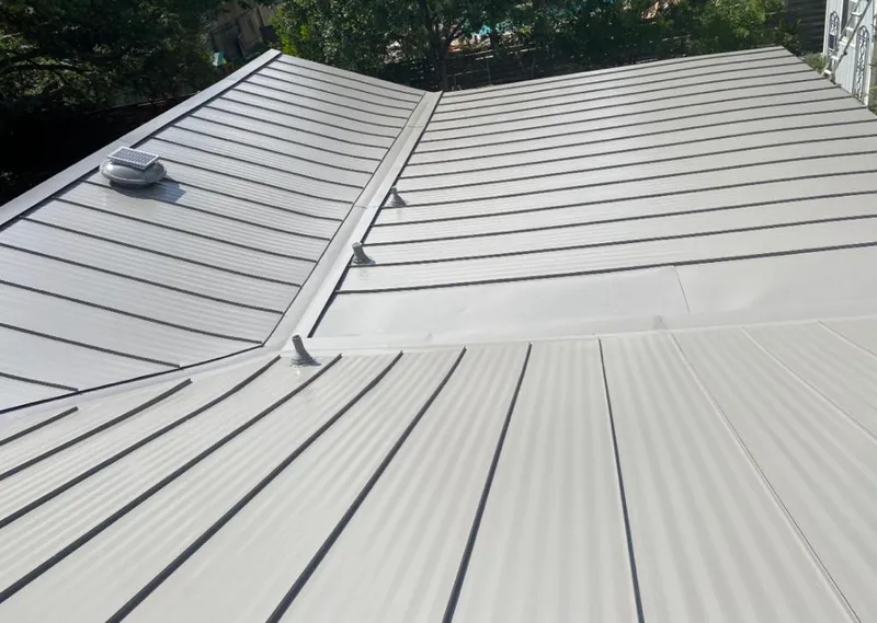 Solar attic fan installed on a metal roof for Roof Ventilation in North Kansas City
